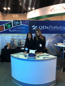 QDx employees at booth in San Diego, CA